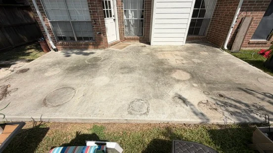 Patio before cleaning, showing visible buildup and circular marks